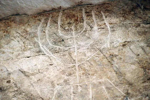 A seven-branched candelabra, or menorah, seen inscribed above the entrance to the oil press.