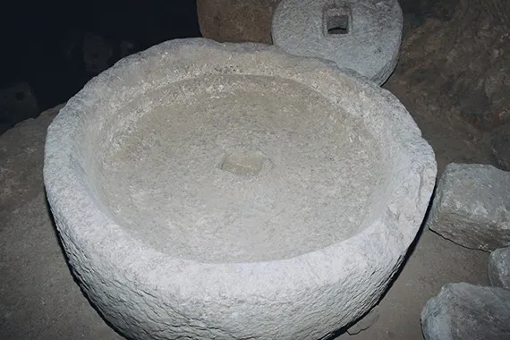 The massive stone basin used for grinding the olives, the first step in the oil production.