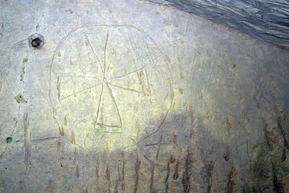 A Maltese cross inscribed into one of the chamber walls.
